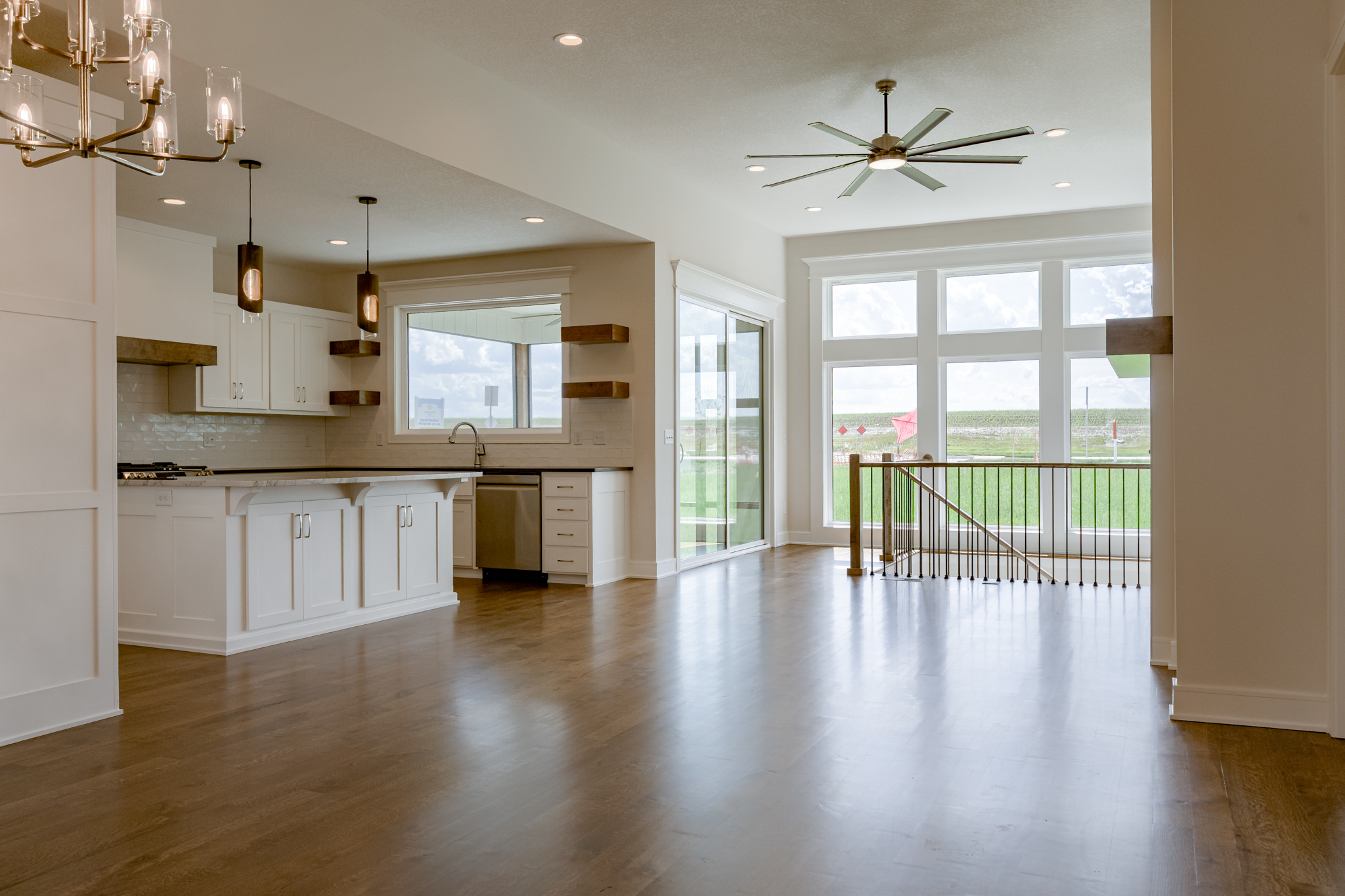 The Truman reverse 1.5-story floor plan with open concept kitchen and great room by Patriot Homes.