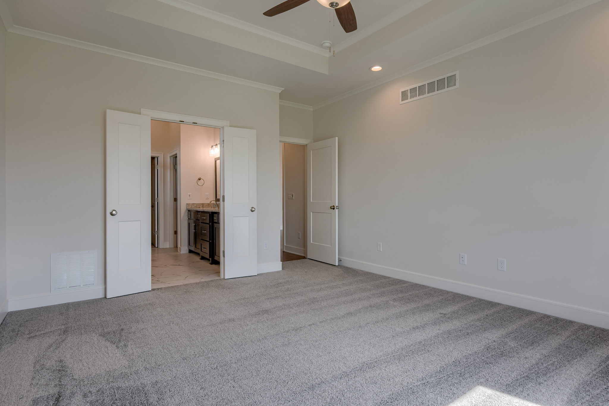The Truman reverse 1.5-story floor plan master bedroom by Patriot Homes.