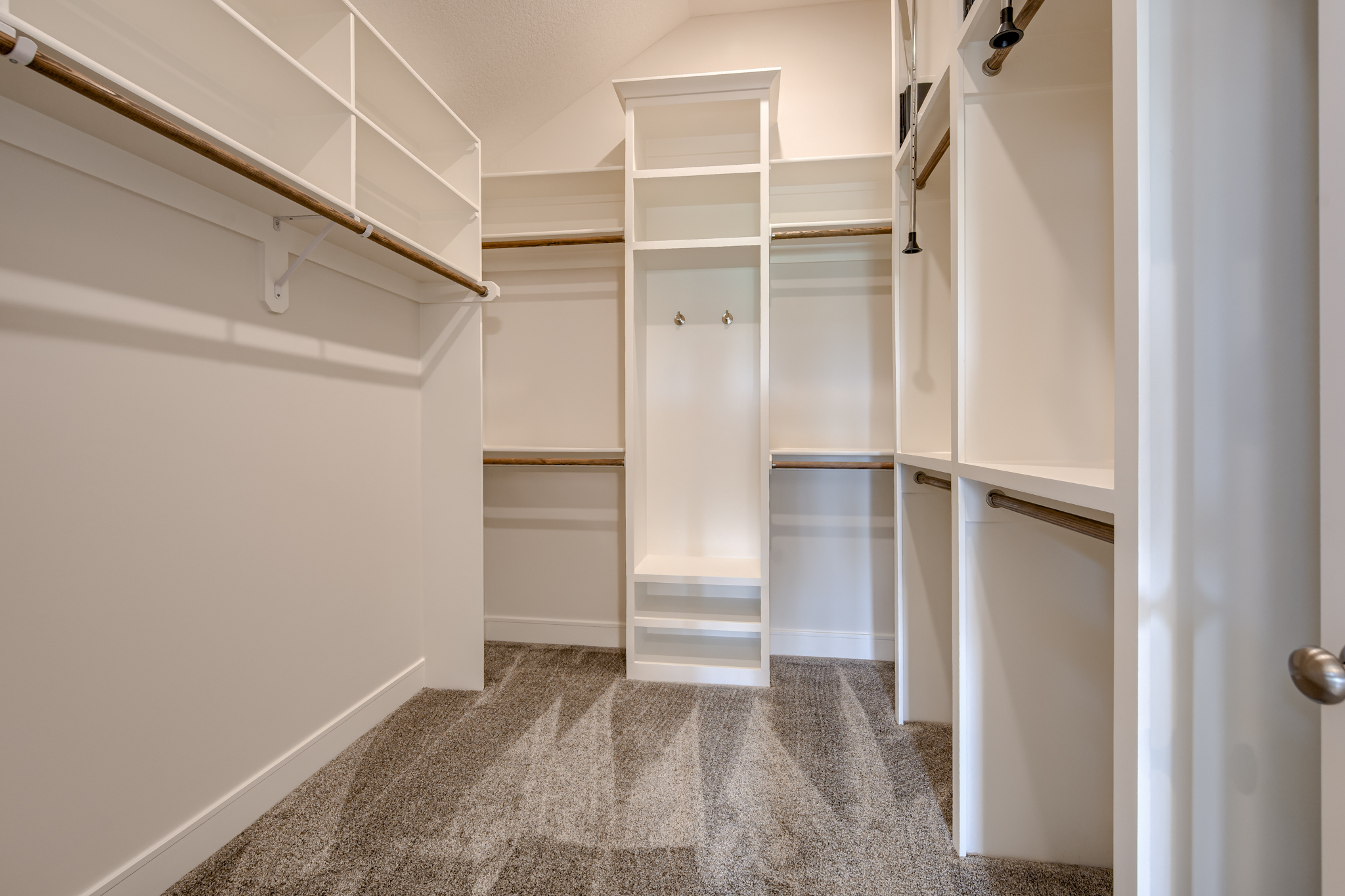 The Truman reverse 1.5-story floor plan master bedroom closet with three-season storage by Patriot Homes.