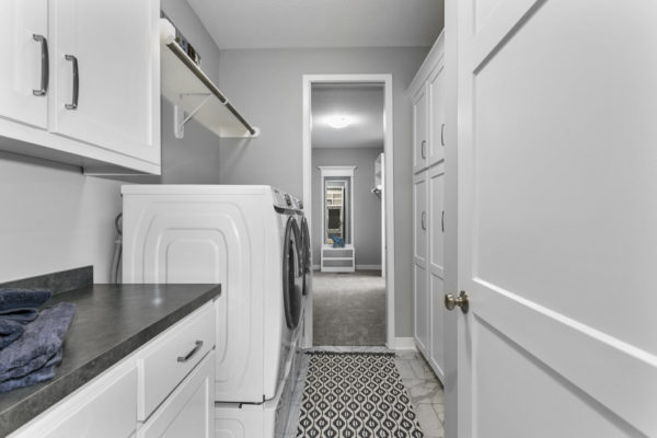 The Jefferson 1.5-story floor plan main level laundry room with connectivity to the master bedroom walk-in closet.