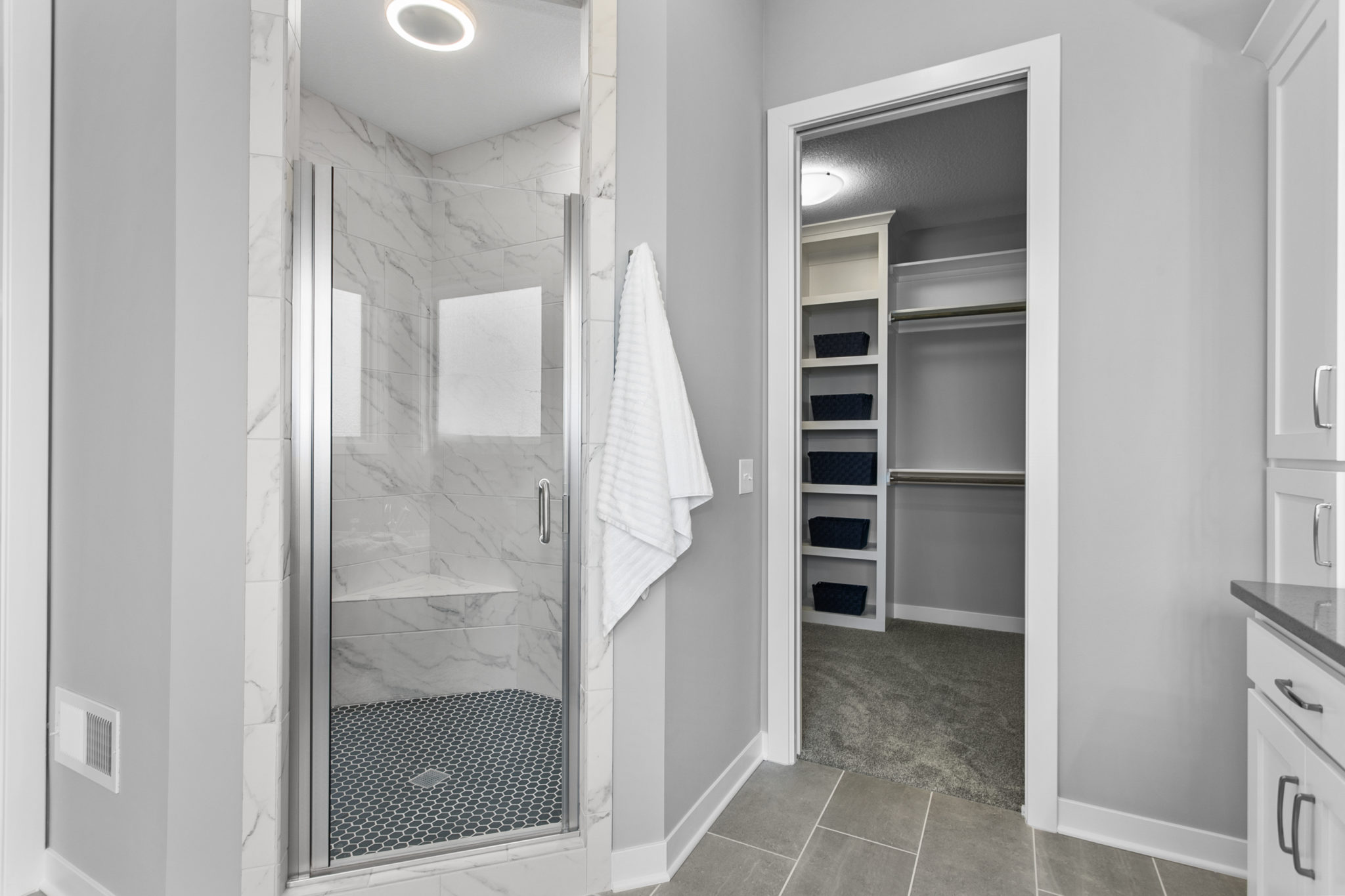 The Jefferson 1.5-story floor plan main level master bathroom walk-in shower with dual shower heads and built-in Bluetooth audio.
