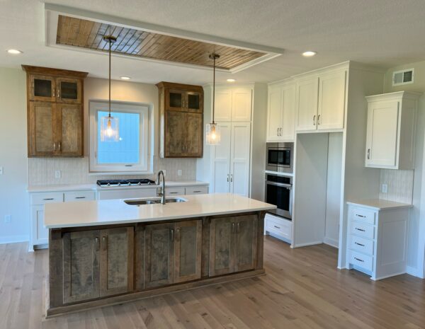 The Taft reverse 1.5-story floor plan kitchen with stained and painted enameled white cabinets.